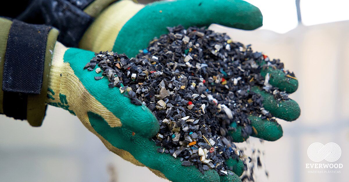 Hands holding shredded recycled plastic flakes for Everwood