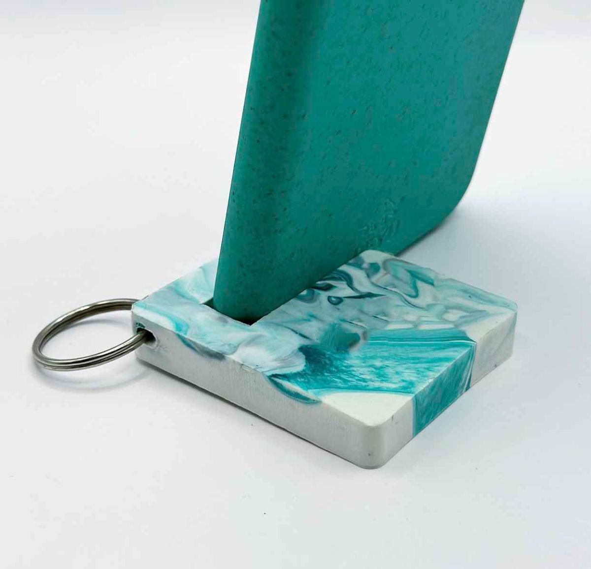 Phone stand keychain in marbled teal plastic