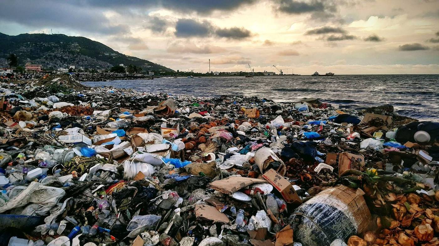 Shoreline covered in plastic waste at Cap-Haïtien, Haiti — Caribbean, not Miami